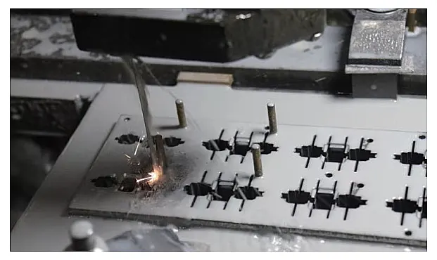 Figure 9. Positioning the workpiece onto the fixture plate using locating pins